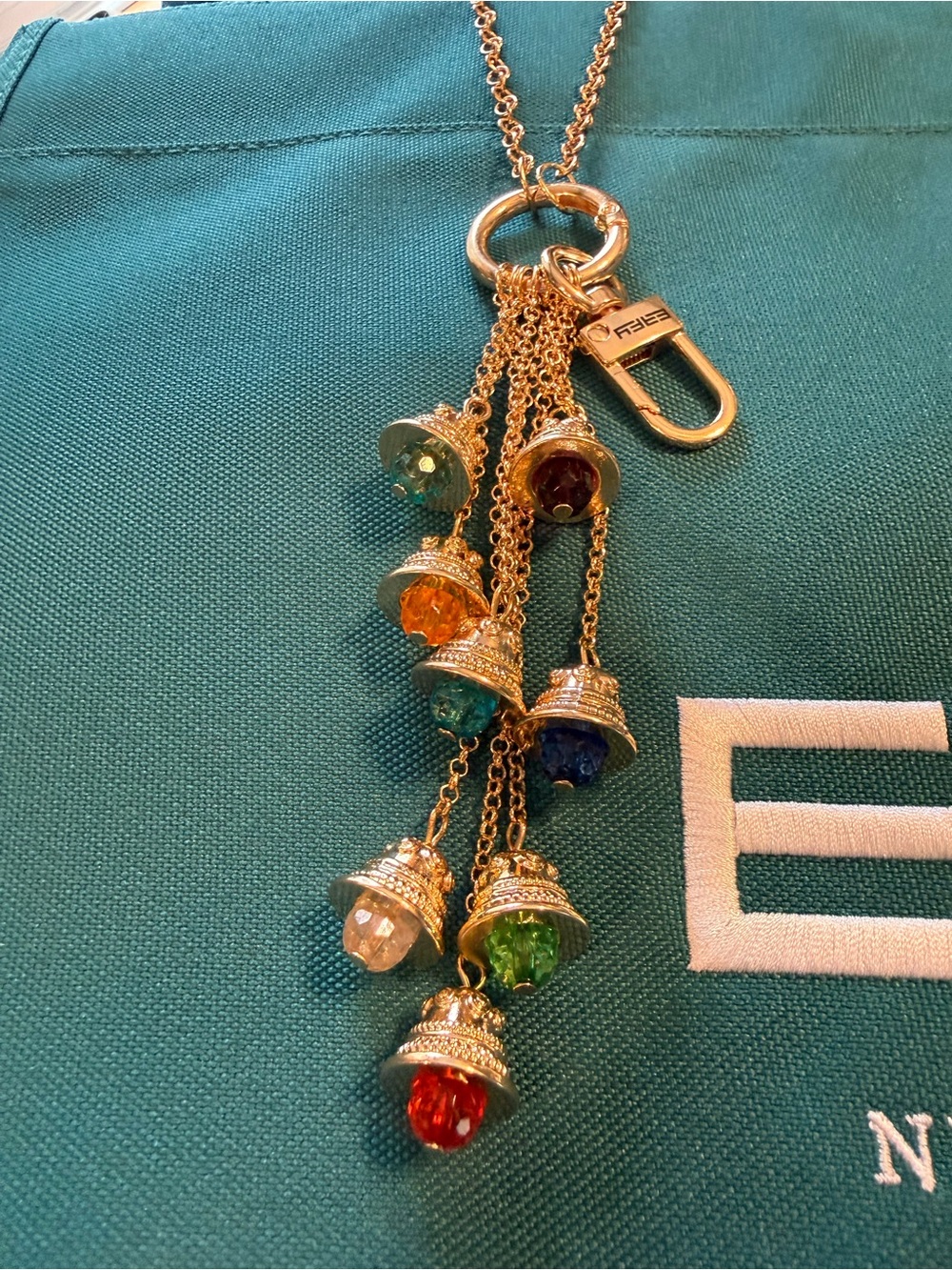 Effy Teal Canvas Logo Tote with Gold color bag charm with 8 Effy bell charms. - Picture 4 of 6